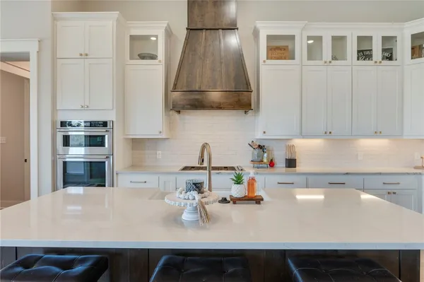 a kitchen with a sink a stove and cabinets