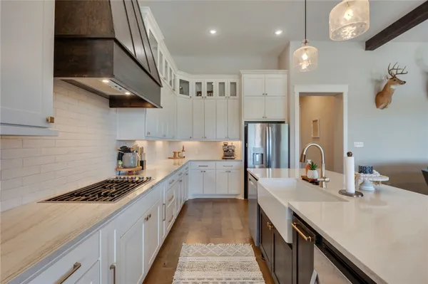 a kitchen with a sink stove and cabinets
