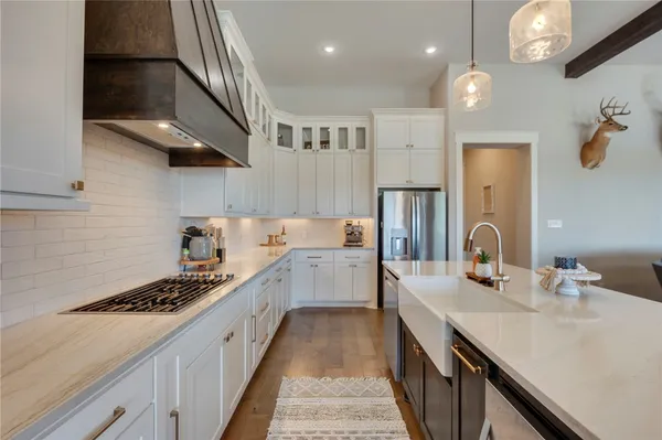 a kitchen with a sink stove and cabinets
