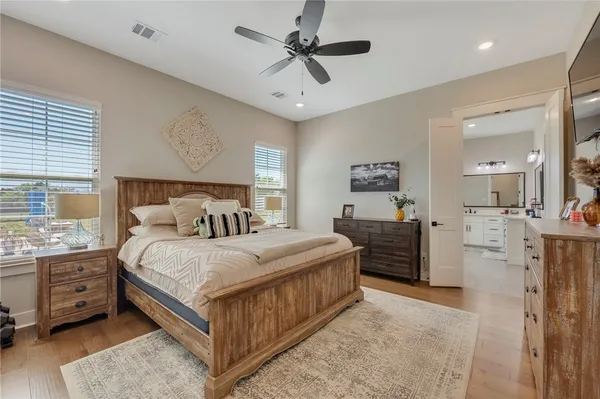 a spacious bathroom with a double vanity sink mirror and bathtub