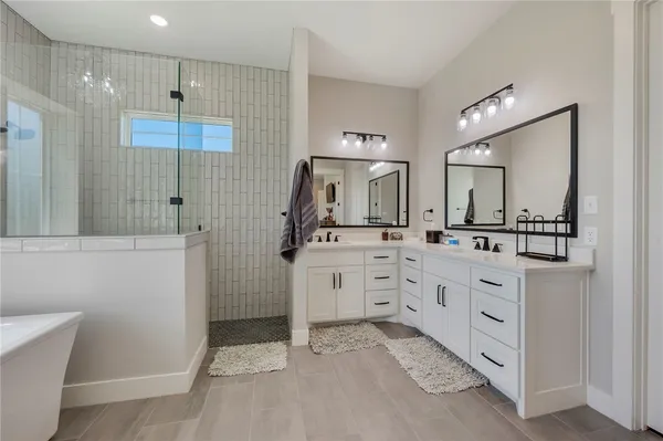 a view of walk in closet with clothes