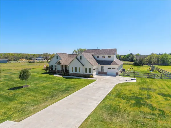 an aerial view of a house with big yard