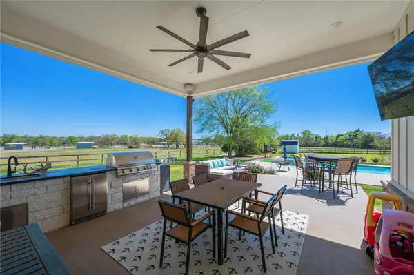 an outdoor sitting area with couch and wooden fence