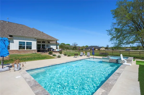 a aerial view of a house with swimming pool garden and patio