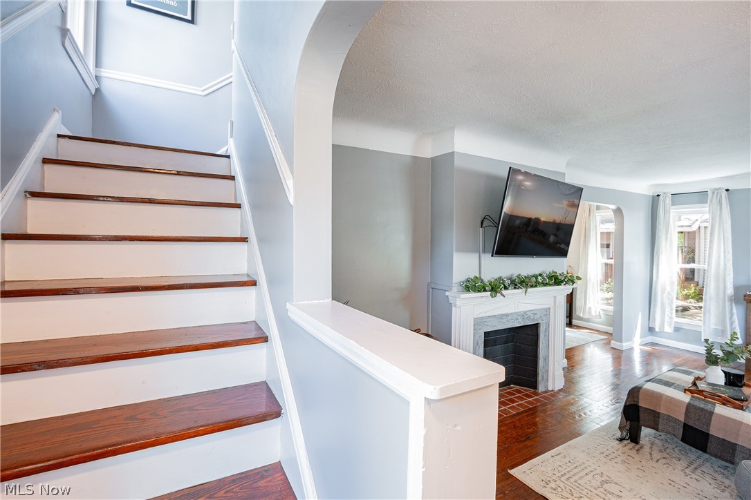 9630 Snow Road Cleveland, OH 44130 - Photo 16 of 31 Staircase featuring dark wood-type flooring and a textured ceiling
