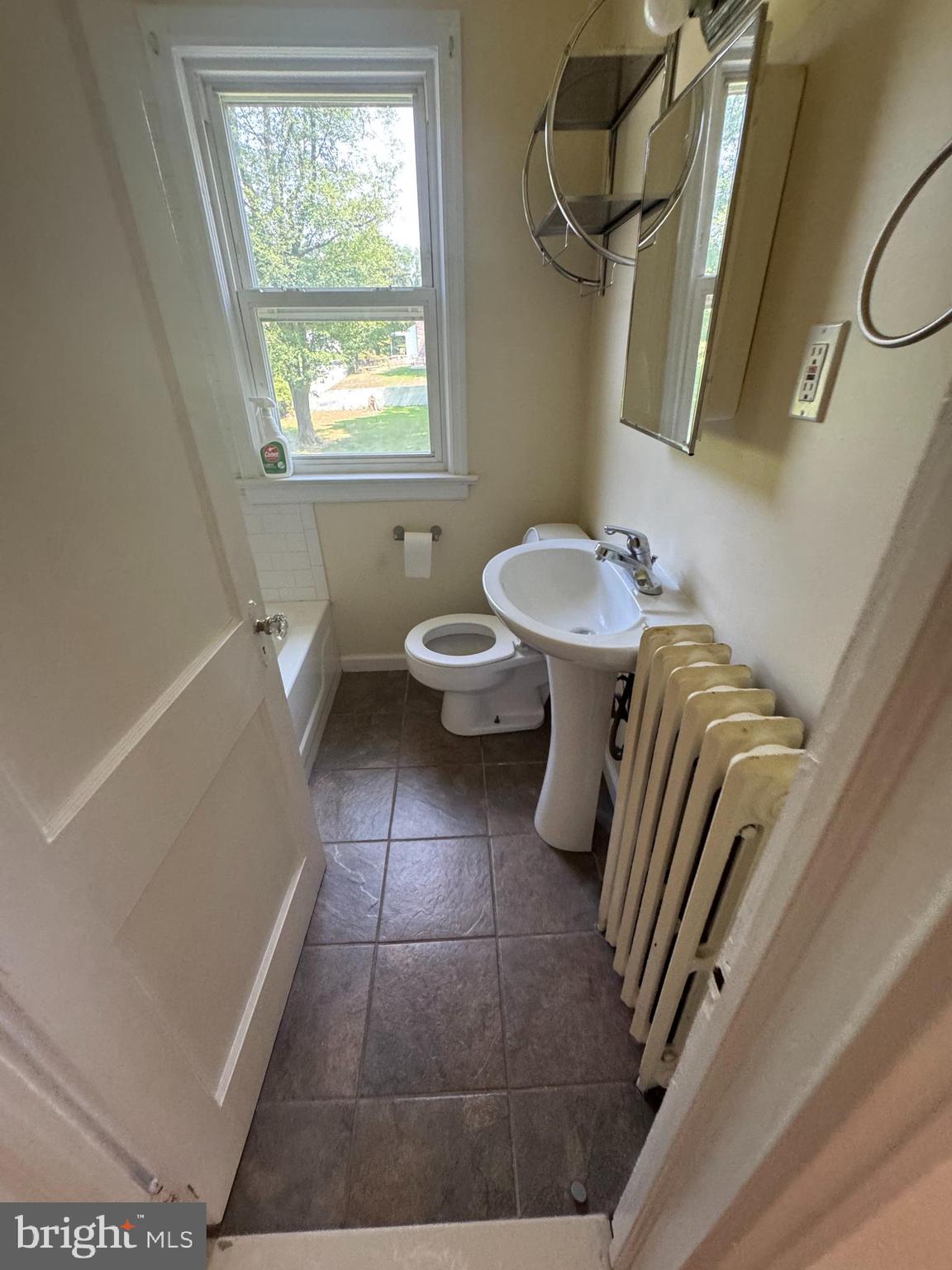844 Lower Ferry Road, Unit B Ewing, NJ 08628 - Photo 6 of 6 a bathroom with a sink a toilet and a window