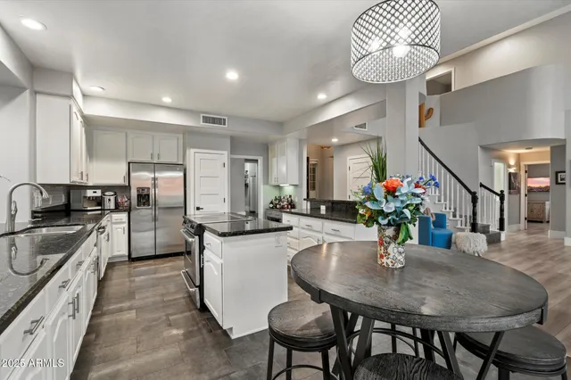 a spacious bathroom with double vanity a mirror a bathtub and a shower