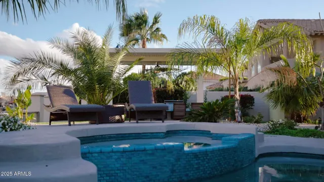 a view of a patio with table and chairs potted plants and palm tree