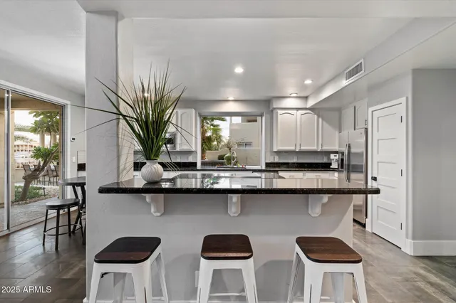 a kitchen with granite countertop a stove a sink and a granite counter tops
