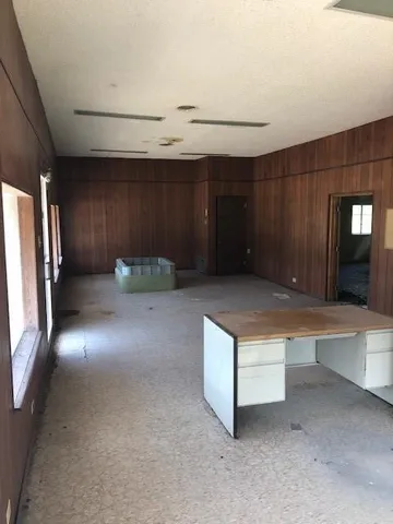 a living room with stainless steel appliances kitchen island granite countertop furniture and a fireplace