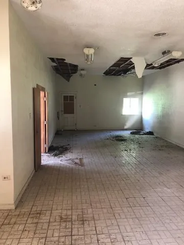 a view of a livingroom with a ceiling fan and window
