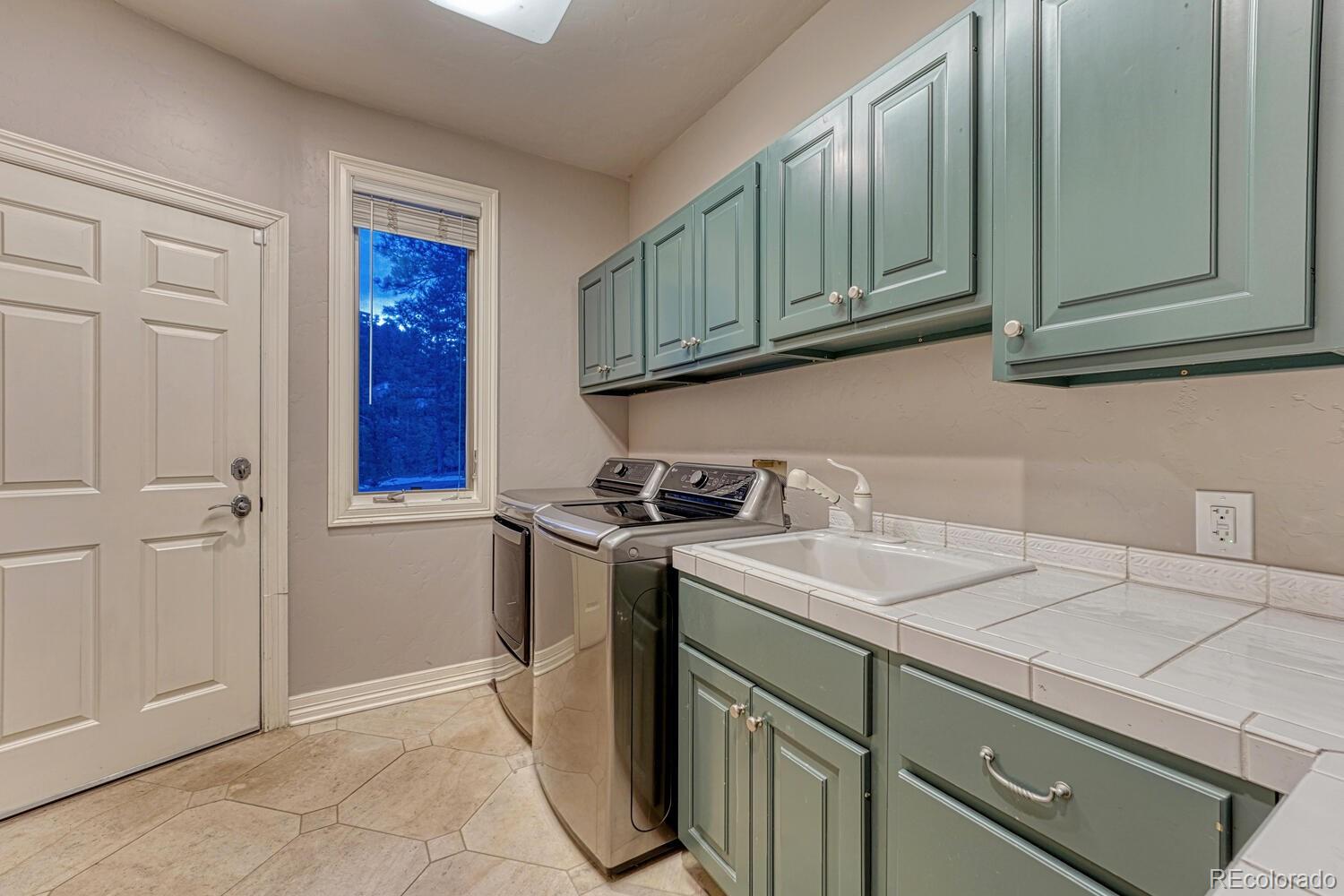 26344 Independence Trail Evergreen, CO 80439 - Photo 14 of 50 a view of a storage and utility room with washer and dryer