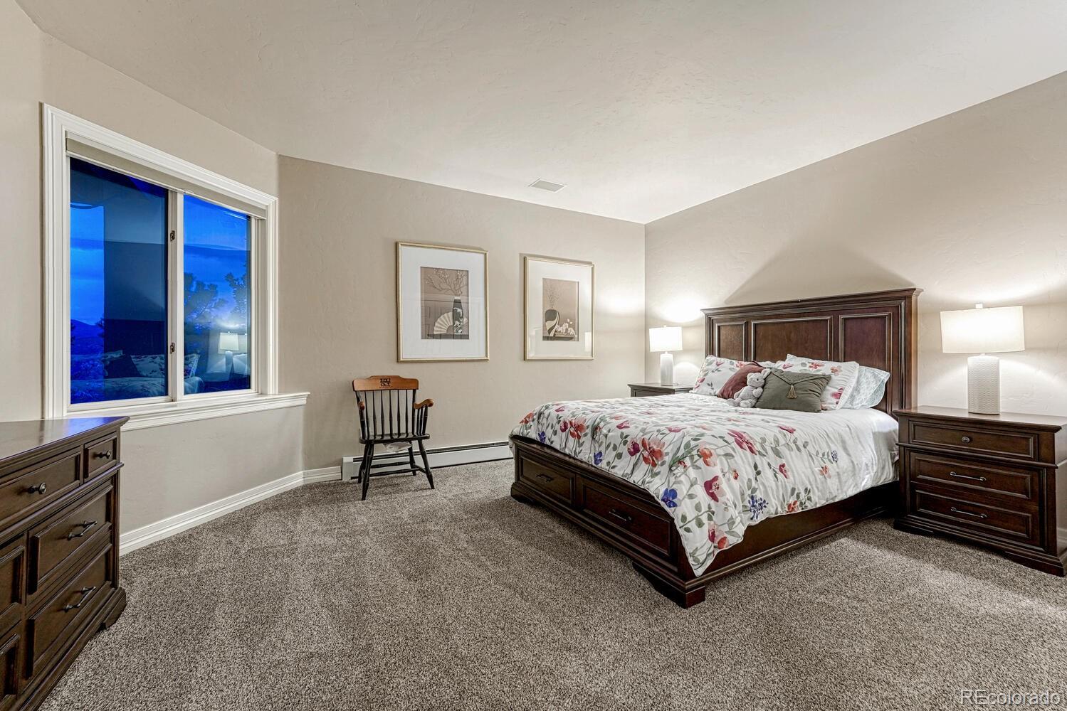 26344 Independence Trail Evergreen, CO 80439 - Photo 15 of 50 a spacious bedroom with a bed and a window