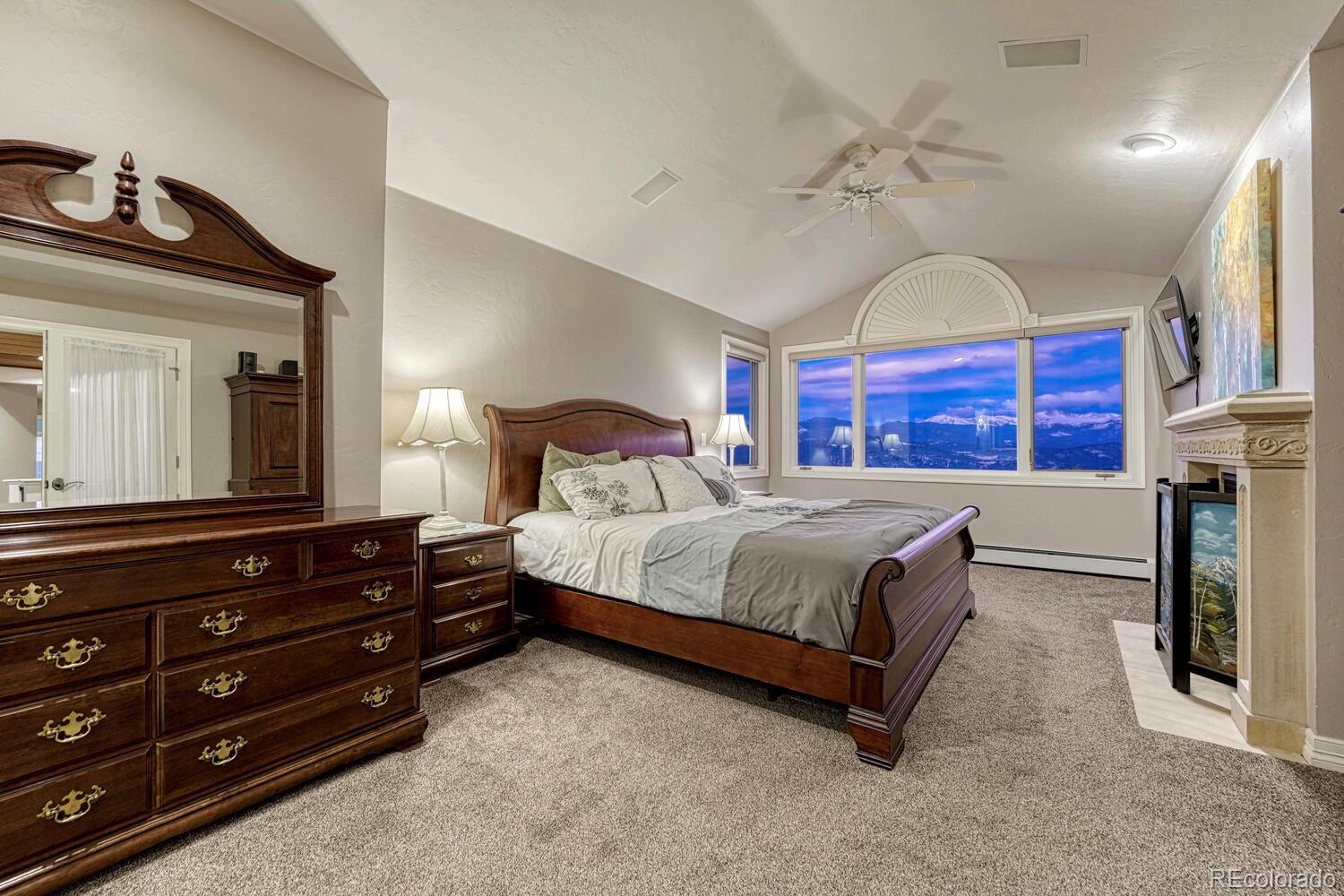 26344 Independence Trail Evergreen, CO 80439 - Photo 17 of 50 a bedroom with a bed and wooden floor