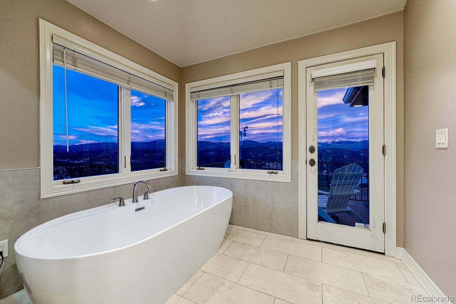 26344 Independence Trail Evergreen, CO 80439 - Photo 20 of 50 a white bath tub sitting next to a window