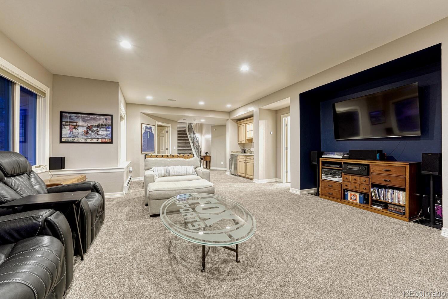 26344 Independence Trail Evergreen, CO 80439 - Photo 24 of 50 a living room with furniture and a flat screen tv
