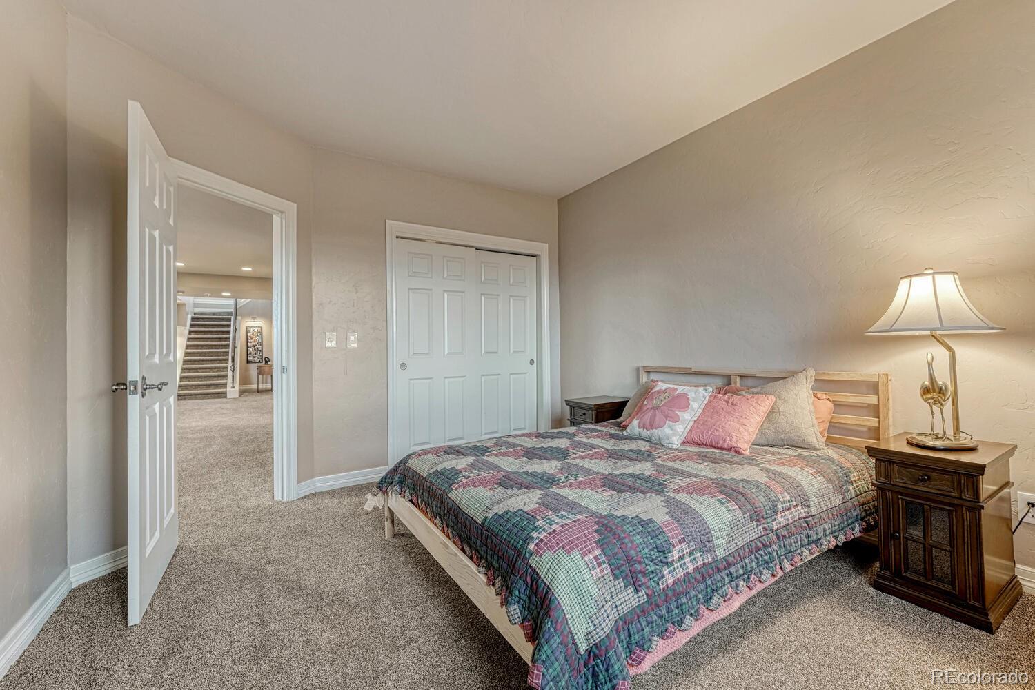 26344 Independence Trail Evergreen, CO 80439 - Photo 26 of 50 a bedroom with a bed and a lamp