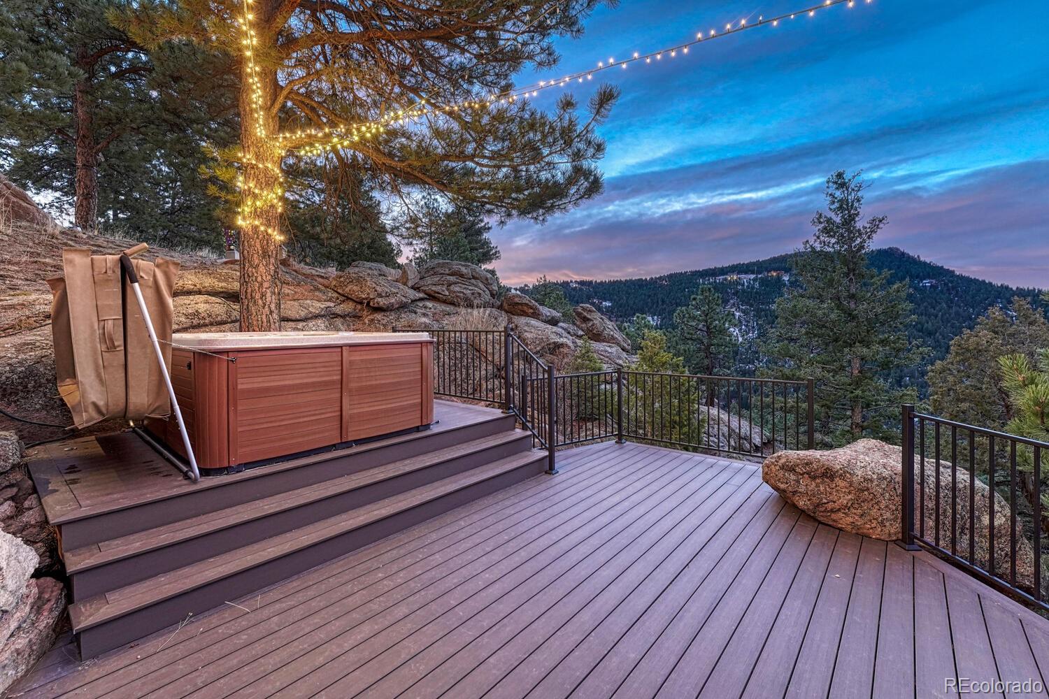 26344 Independence Trail Evergreen, CO 80439 - Photo 27 of 50 a view of a roof deck with wooden floor and outdoor seating