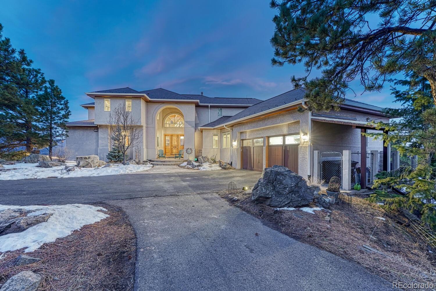 26344 Independence Trail Evergreen, CO 80439 - Photo 3 of 50 a front view of a house with garden