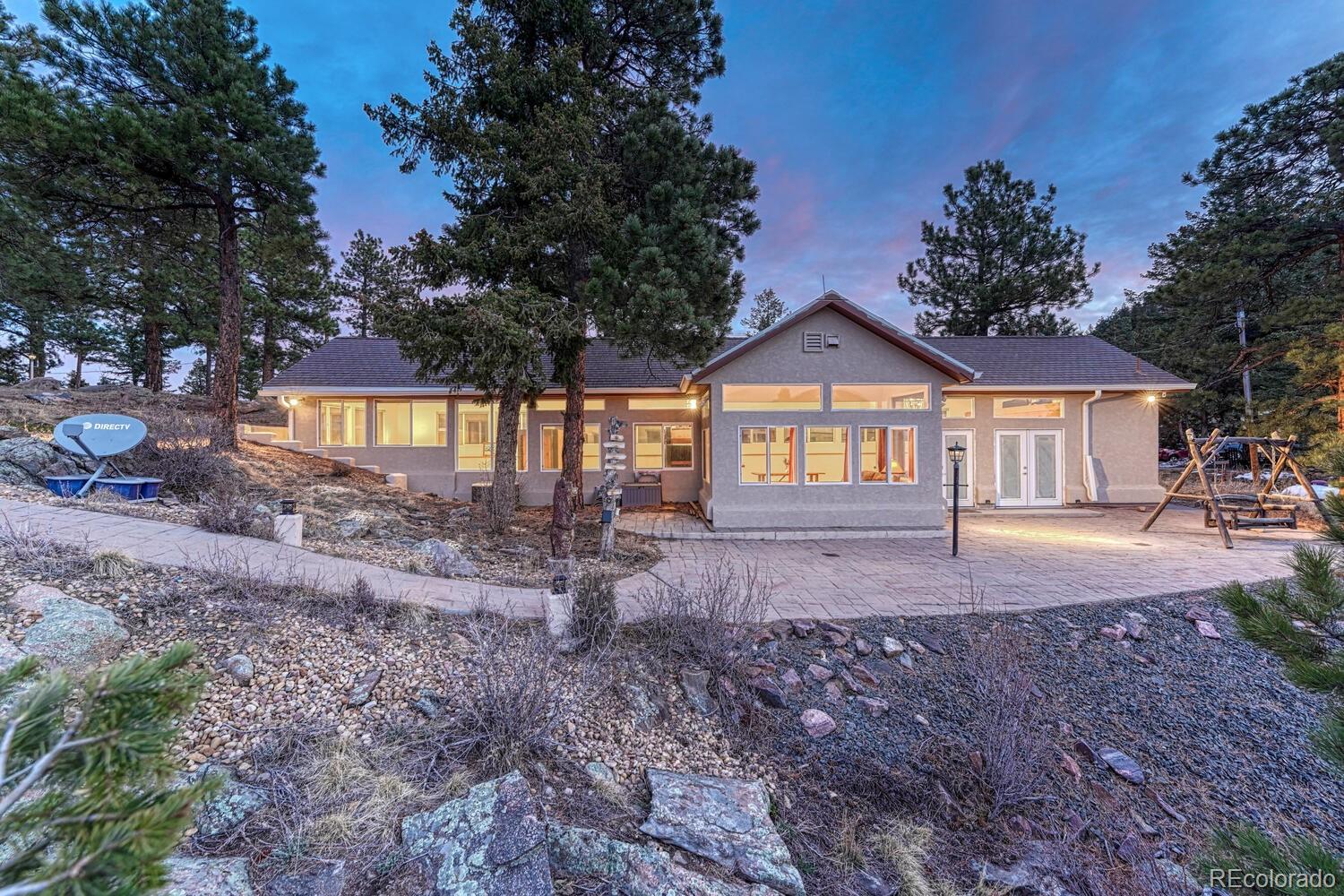 26344 Independence Trail Evergreen, CO 80439 - Photo 31 of 50 a front view of a house with a garden