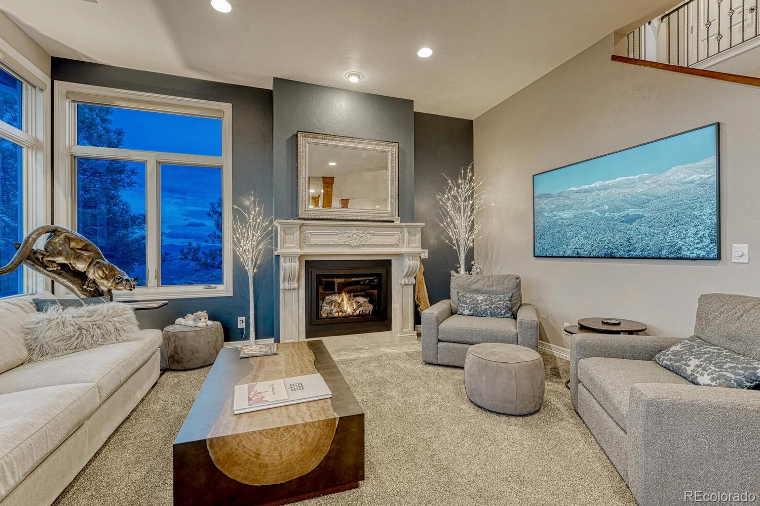 26344 Independence Trail Evergreen, CO 80439 - Photo 9 of 50 a living room with furniture and a fireplace
