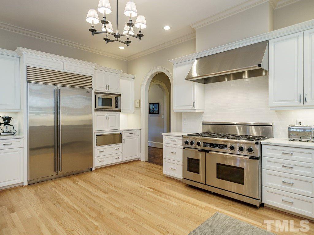 2304 White Oak Road Raleigh, NC 27608 - Photo 11 of 30 a kitchen with stainless steel appliances granite countertop a stove and a refrigerator