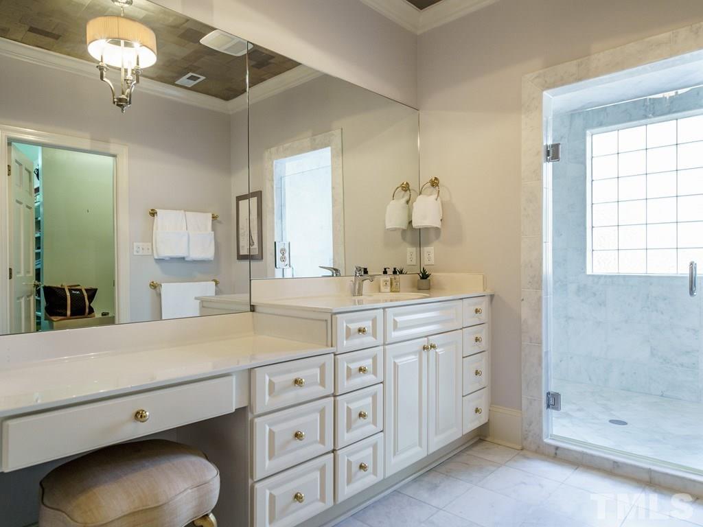 2304 White Oak Road Raleigh, NC 27608 - Photo 19 of 30 a spacious bathroom with a granite countertop sink a toilet a mirror and shower