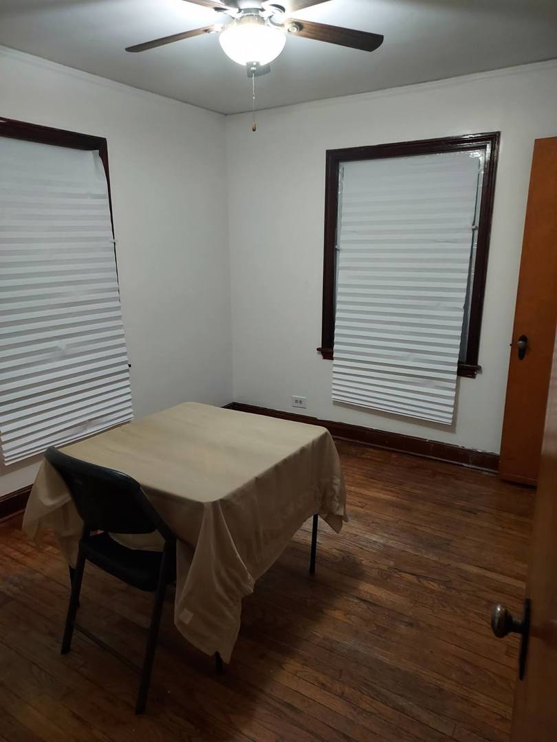 104 East 150th Street Harvey, IL 60426 - Photo 14 of 25 a balcony with a table and chairs