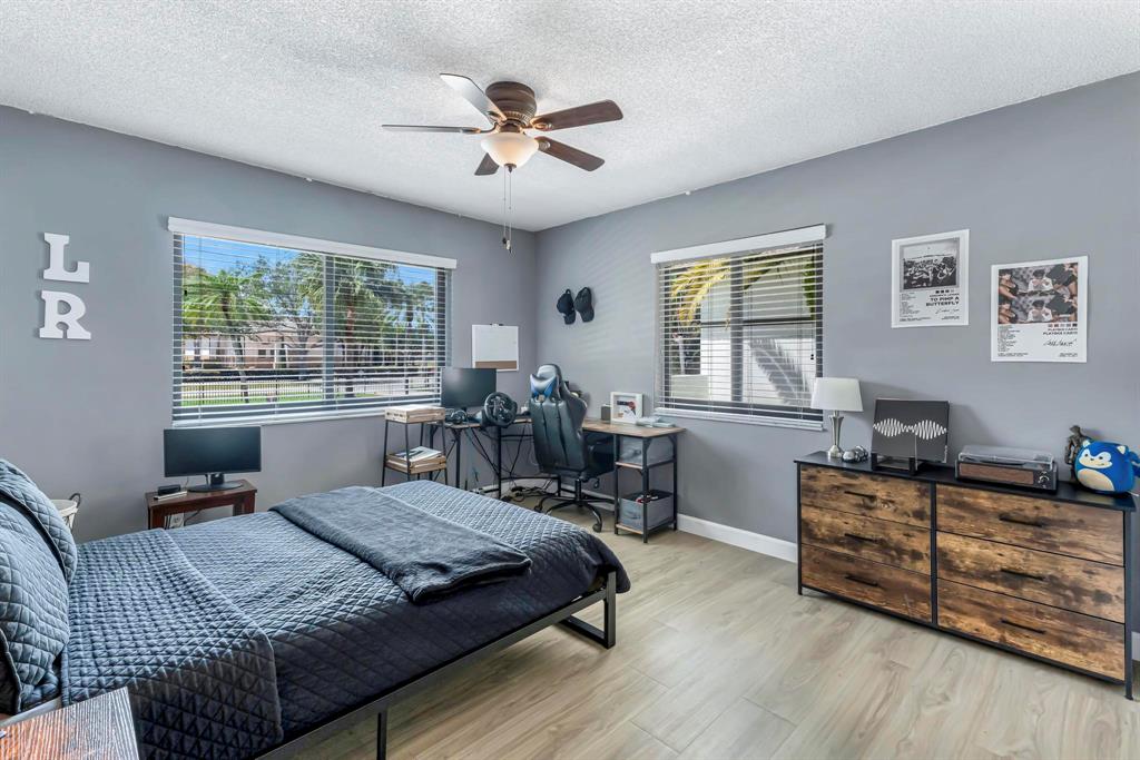 4600 Southwest 164th Terrace Southwest Ranches, FL 33331 - Photo 15 of 36 a bedroom with a bed a dresser and chair