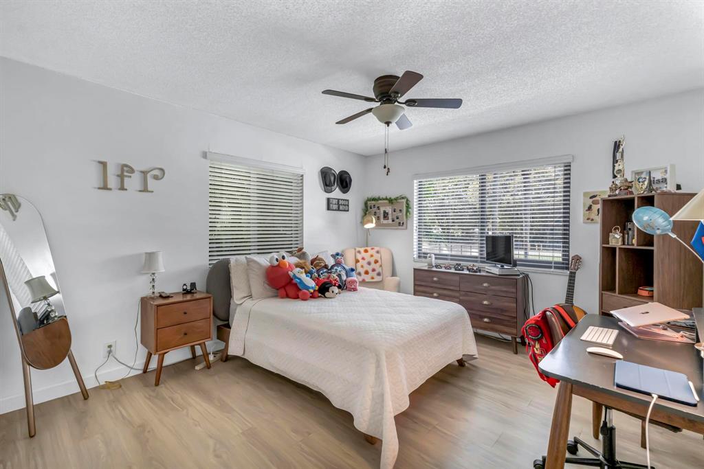 4600 Southwest 164th Terrace Southwest Ranches, FL 33331 - Photo 18 of 36 a bedroom with a bed and wooden floor