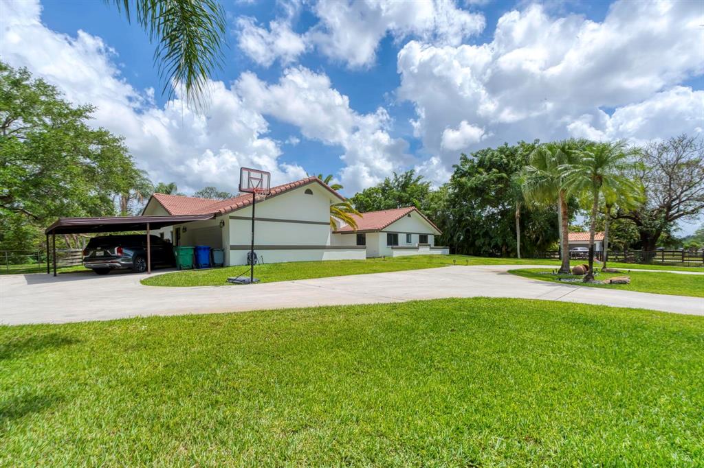 4600 Southwest 164th Terrace Southwest Ranches, FL 33331 - Photo 31 of 36 a view of a house with swimming pool and a yard