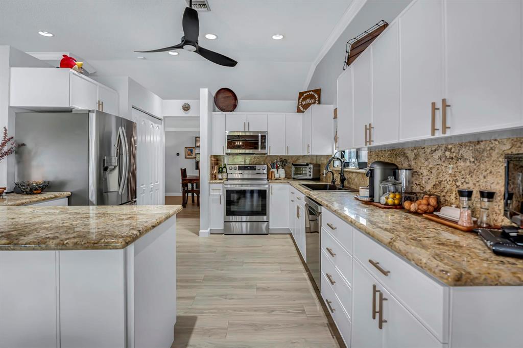 4600 Southwest 164th Terrace Southwest Ranches, FL 33331 - Photo 8 of 36 a large kitchen with stainless steel appliances granite countertop a lot of counter space and a sink