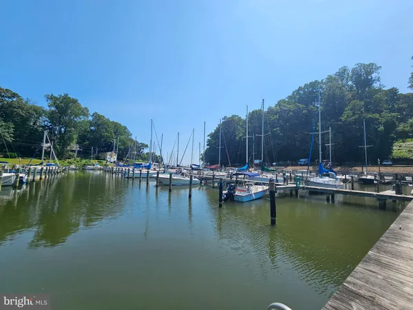 a view of swimming pool with outdoor seating and lake view