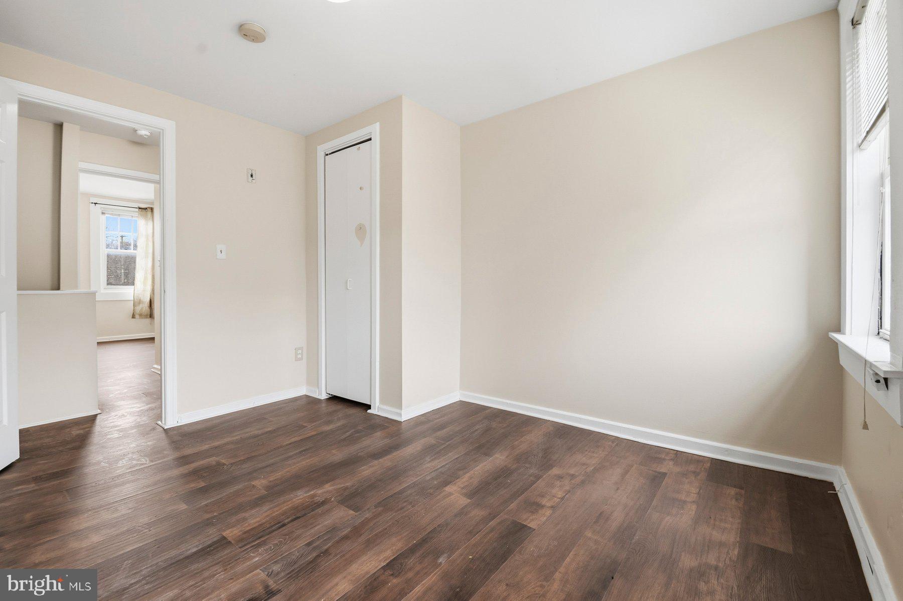 229 South Fremont Avenue Baltimore, MD 21230 - Photo 18 of 25 a view of an empty room with wooden floor