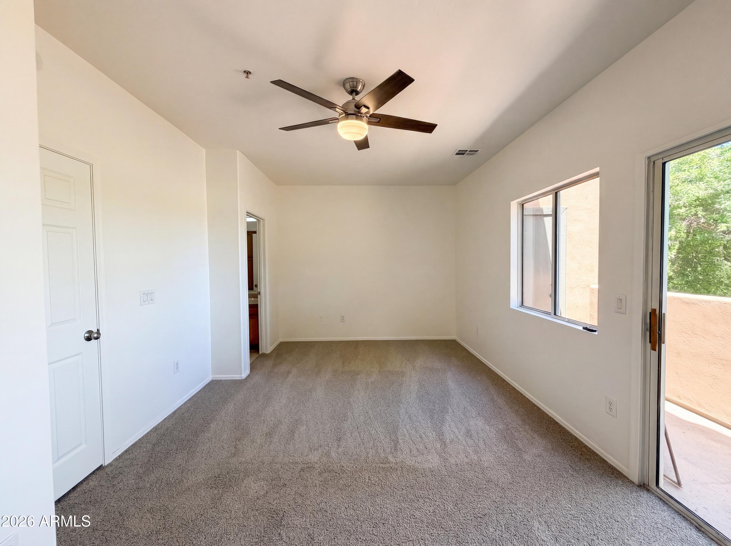 1718 West Colter Street, Unit 174 Phoenix, AZ 85015 - Photo 11 of 21 a view of an empty room with a window