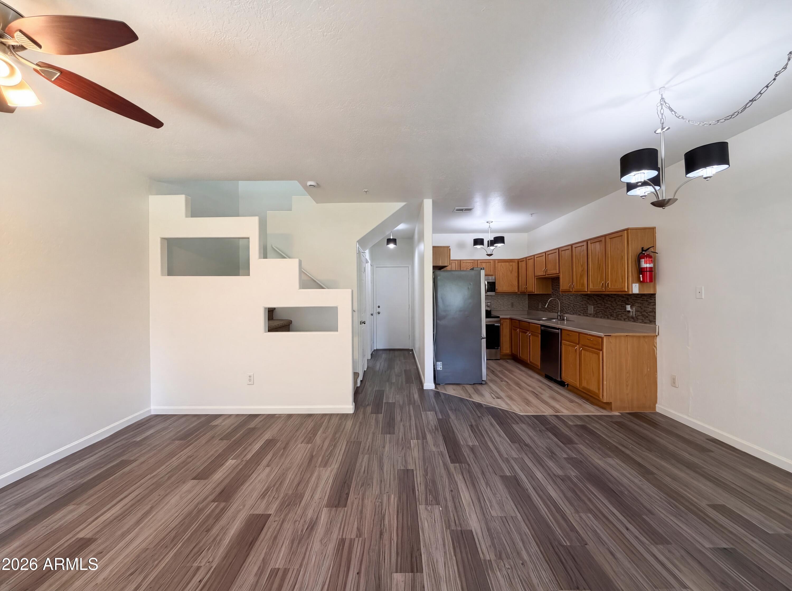 1718 West Colter Street, Unit 174 Phoenix, AZ 85015 - Photo 3 of 21 a big room with wooden floor