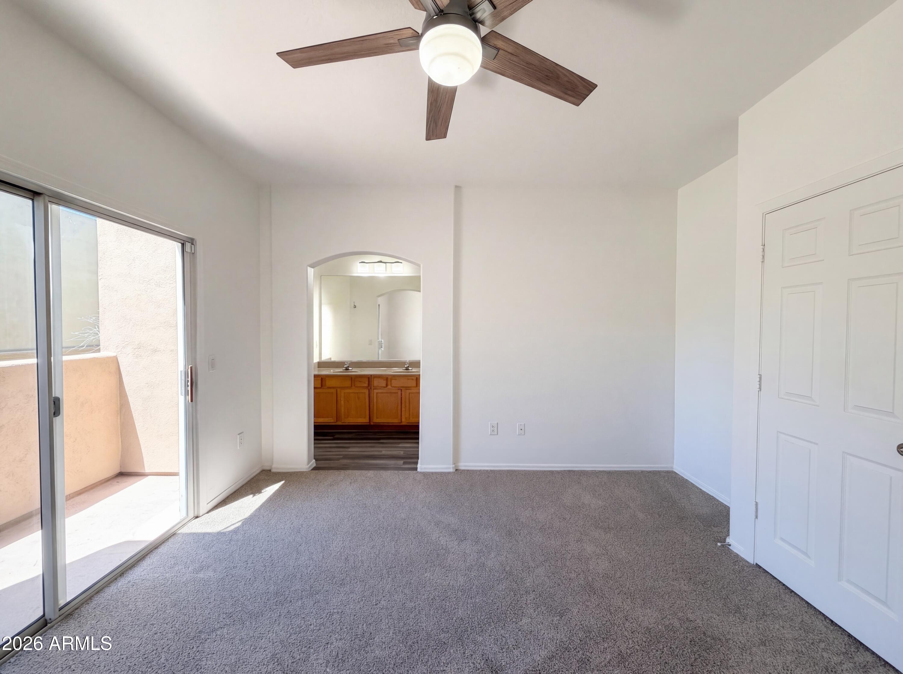 1718 West Colter Street, Unit 174 Phoenix, AZ 85015 - Photo 4 of 21 a view of a room with closet and a ceiling fan