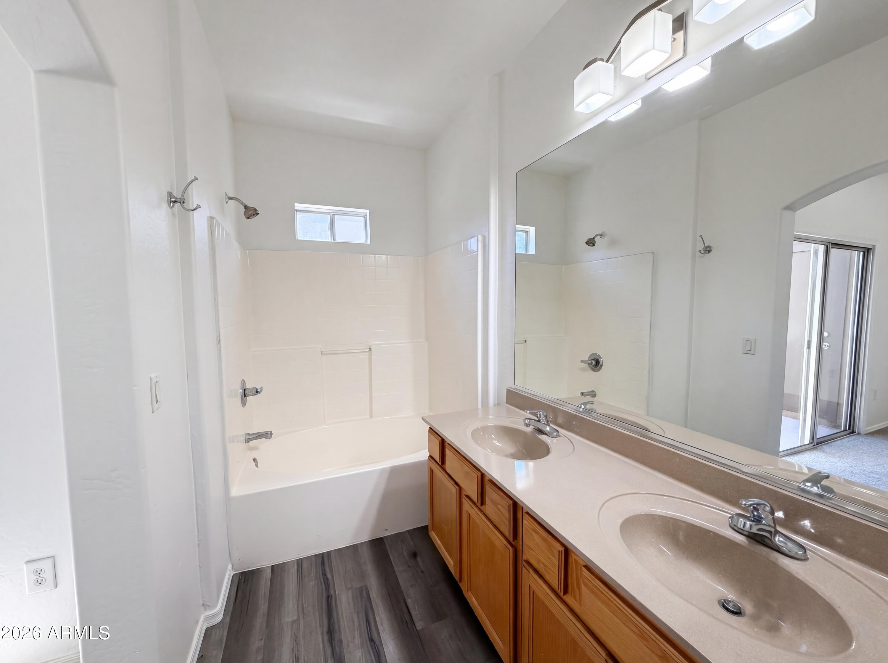1718 West Colter Street, Unit 174 Phoenix, AZ 85015 - Photo 7 of 21 a bathroom with a tub a sink and mirrors