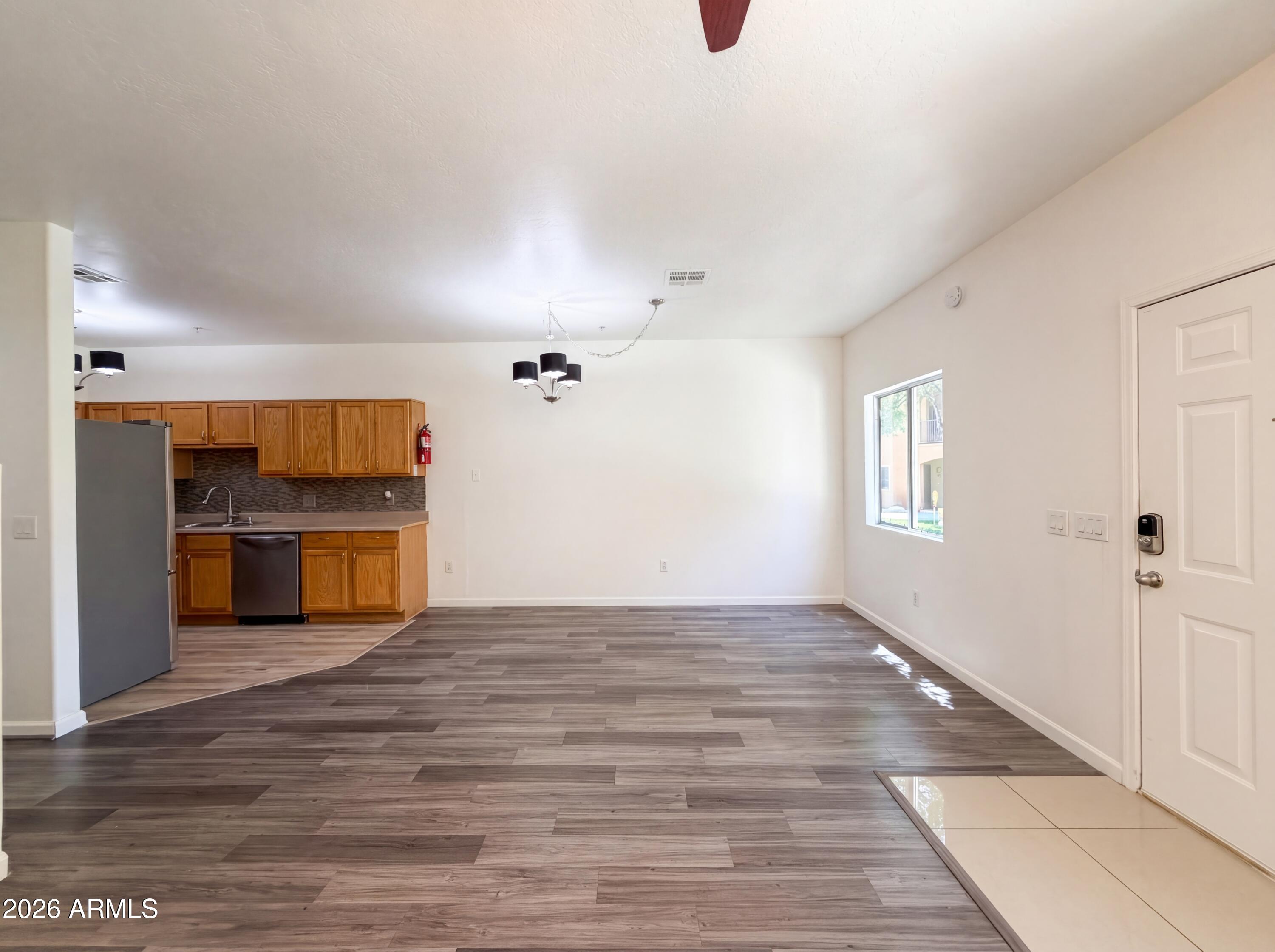 1718 West Colter Street, Unit 174 Phoenix, AZ 85015 - Photo 9 of 21 a view of a hallway with a kitchen