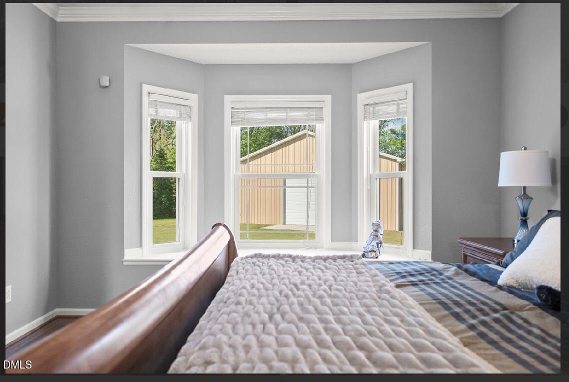 5780 McArthur Road Broadway, NC 27505 - Photo 21 of 40 a bedroom with a bed and a large window
