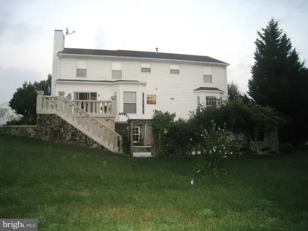 a view of a white house with a fence