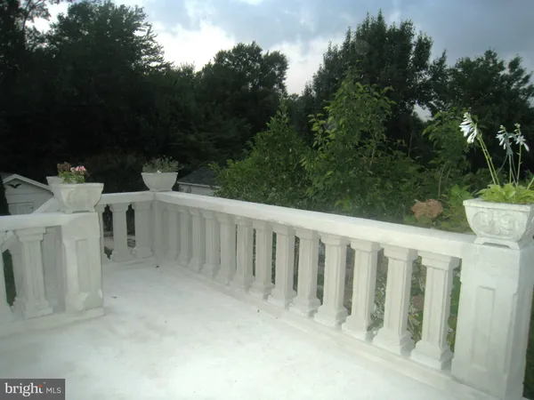 a view of an empty room with window and closet area