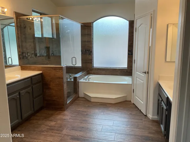 a bathroom with a bathtub sink and mirror