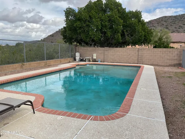 a view of a swimming pool with a yard