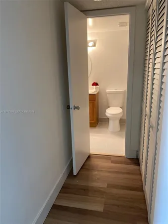 a view of a bathroom with wooden floor and toilet