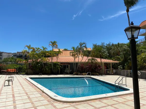 a view of swimming pool with seating space and plants