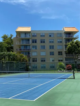 a view of a tall building next to a yard