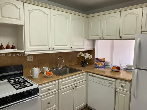 a kitchen with a sink cabinets and appliances