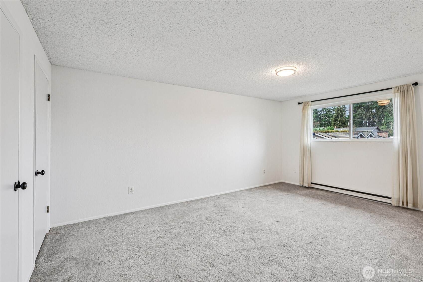 7909 218th Street Southwest, Unit 4 Edmonds, WA 98026 - Photo 16 of 29 an empty room with windows