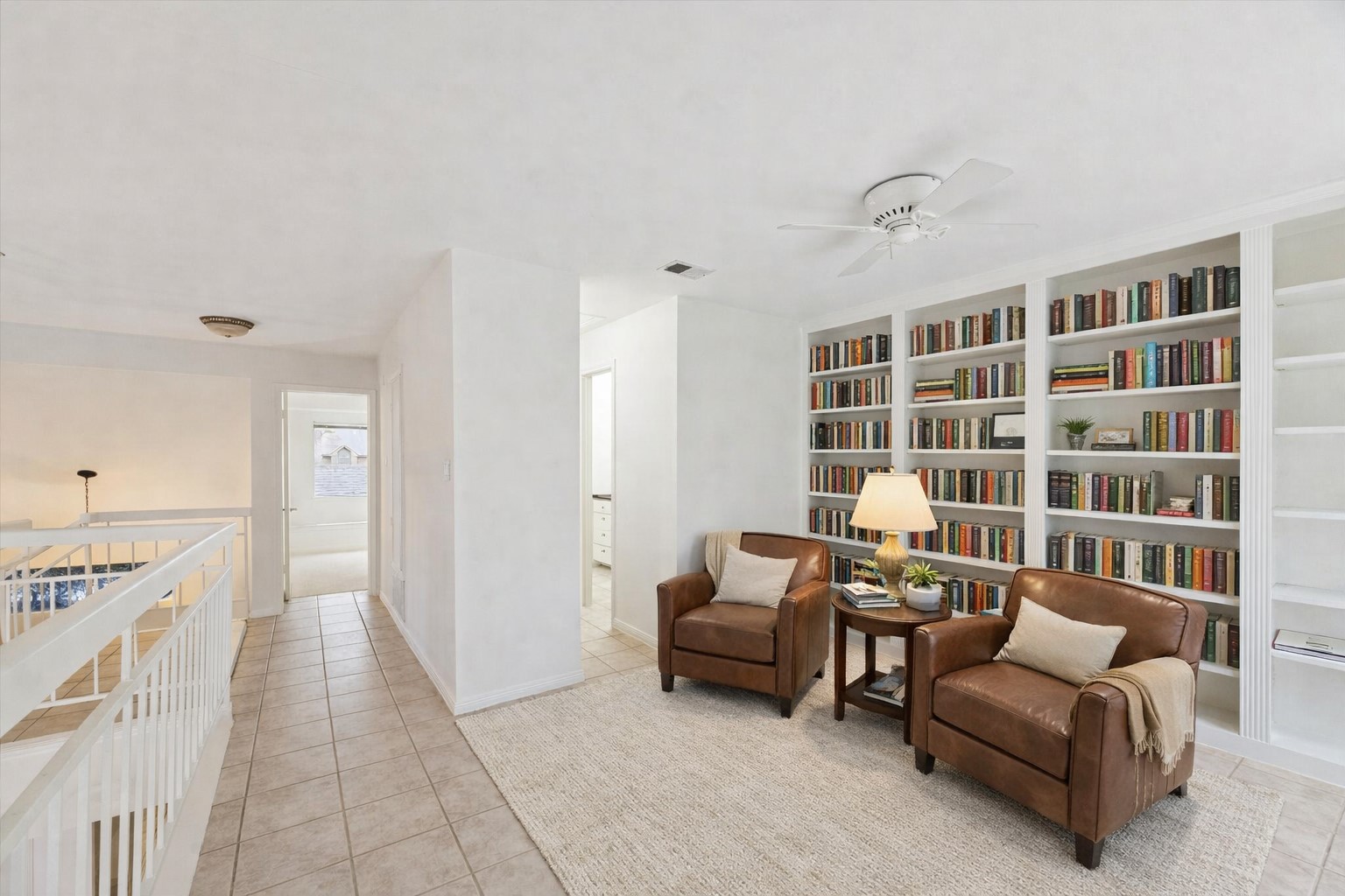 12 Lakeridge Drive Spring, TX 77381 - Photo 17 of 24 Flexible loft space with custom built-in bookshelves, ideal for a second home office, media room, or library overlooking the main floor. Virtually Staged